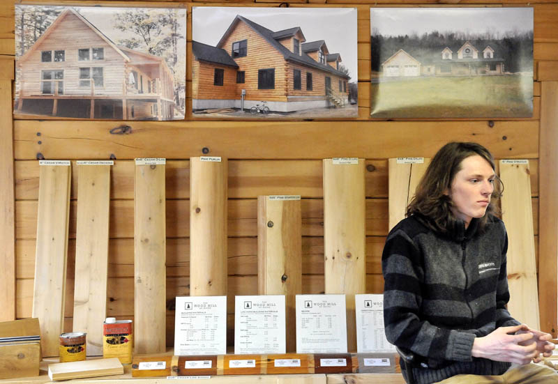 Bjarki Gunnarson sits in front of some of the specialty wood products that his company, The Wood Mill of Maine, which he co-owns with his friend, Josh Saltmarsh, on Mercer Road in Mercer.