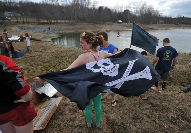 Summer Nay, 20, flies her skull and crossbones flag before the first cardboard kayak race at Unity College on Friday.