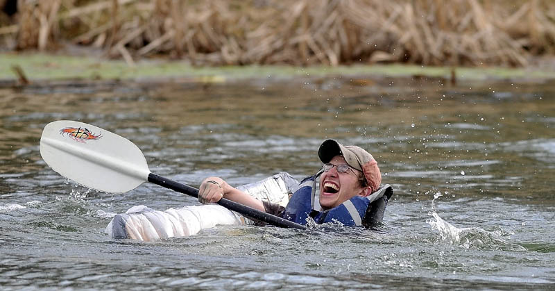 Taylor Noble, 21, struggles to stay afloat in the second heat during the first cardboard kayak race at Unity College on Friday.