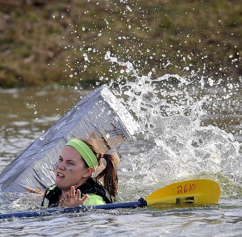 Rebecca Fisher, 20, struggles to stay afloat in the fourth heat during the first cardboard kayak race at Unity College on Friday.