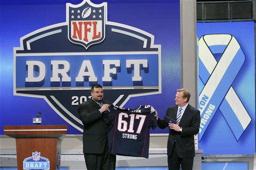 Former New England Patriots guard Joe Andruzzi, who assisted in rescuing in rescue an injured victim from the Boston Marathon attack, and NFL commissioner Roger Goodell honor the victims and first responders of the bombings during the first round of the NFL football draft, Thursday, April 25, 2013 at Radio City Music Hall in New York. (AP Photo/Mary Altaffer)
