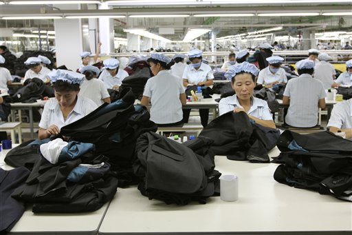 In this Sept. 21, 2012, photo, North Korean workers assemble Western-style suits at the South Korean-run ShinWon Corp. garment factory inside the Kaesong industrial complex in Kaesong, North Korea.