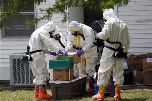Federal agents wearing hazardous material suits and breathing apparatus inspect the home and possessions of Paul Kevin Curtis in Corinth, Miss., on Friday. Curtis is in custody under the suspicion of sending letters covered in ricin to President Barack Obama and U.S. Sen. Roger Wicker, R-Miss.
