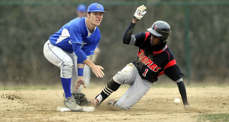 Colby College second baseman Tyler Starks, 1,left, loses his glove as Thomas College's Anree Benitez, 1, slides in to second base ahead of the ball on a steal in the fourth inning at Thomas College in Waterville Tuesday.