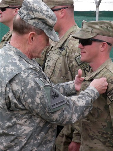 U.S. Chairman of the Joint Chiefs of Staff, Gen. Martin Dempsey, pins a Combat Infantrymen Badge on an unidentified soldier at Forward Operating Base Sharana in Afghanistan's Paktika province during his visit to the base Sunday.