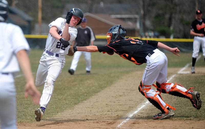Waterville Senior High School's Kaleb Kane, 22, evades the tag from Winslow High School catcher Bobby Chenard, 4, in the first inning Waterville Senior High in Waterville on Friday.
