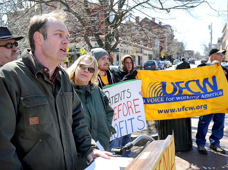 Matt Schlombohm, executive director of the Maine AFL-CIO, speaks about the ability of workers at Wellness Connection to unionize, at a news conference in Longfellow Square in Portland on Saturday.