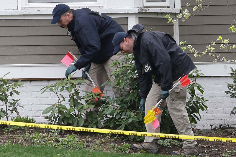 Investigators on Saturday work near the location where the previous night a suspect in the Boston Marathon bombings was arrested in Watertown.