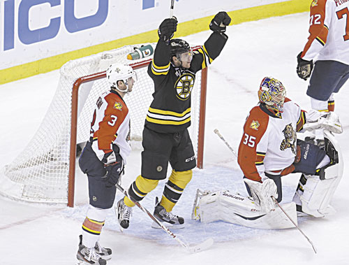 IT’S GOOD: Boston’s Daniel Paille, center, celebrates a goal by teammate Dougie Hamilton (not shown) as Florida defenseman T.J. Brennan (3) and goalie Jacob Markstrom (35) look on in the second period Sunday at the TD Garden in Boston.