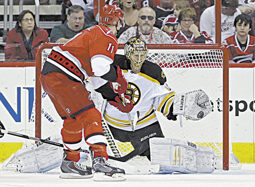 STOPPED: Carolina’s Jordan Staal’s shot is blocked by Boston’s Tuukka Rask during the first period Saturday in Raleigh, N.C.