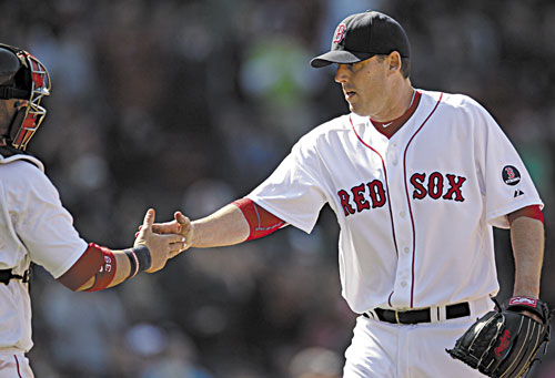 GOOD OUTING: Boston Red Sox starting pitcher John Lackey, right, is congratulated by catcher Jarrod Saltalamacchia after the last out in the sixth inning against the Houston Astros on Sunday at Fenway Park in Boston. Lackey earned his first win in the majors since 2011, allowing one run on five hits while striking out four and walking two.