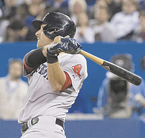 GOING DEEP: Boston’s Will Middlebrooks watches the flight of the ball as he hits a home run off Toronto starter R.A. Dickey during the fifth inning Sunday in Toronto. Middlebrooks was 4 for 5 with three home runs, a double, four RBIs and four runs scored.