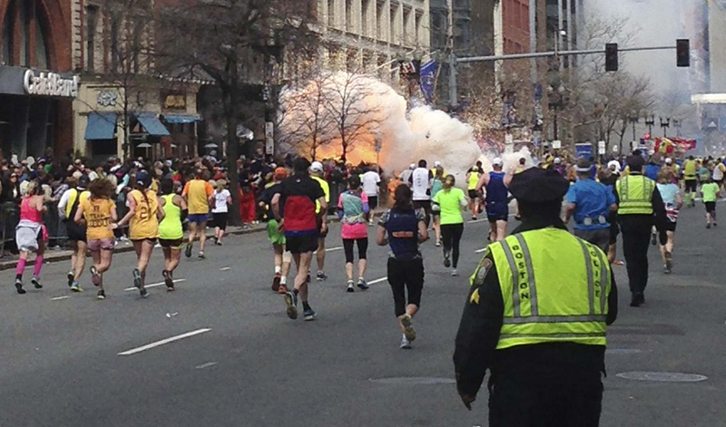 Runners continue to run towards the finish line of the Boston Marathon as an explosion erupts near the finish line of the race in this photo exclusively licensed to Reuters by photographer Dan Lampariello after he took the photo in Boston, Massachusetts, April 15, 2013. Two simultaneous explosions ripped through the crowd at the finish line of the Boston Marathon on Monday, killing at least two people and injuring dozens on a day when tens of thousands of people pack the streets to watch the world famous race. REUTERS EXCLUSIVE REUTERS/Dan Lampariello (UNITED STATES - Tags: CRIME LAW SPORT ATHLETICS TPX IMAGES OF THE DAY ) MANDATORY CREDIT - RTXYN2C :rel:d:bm:GM1E94G0KIH01