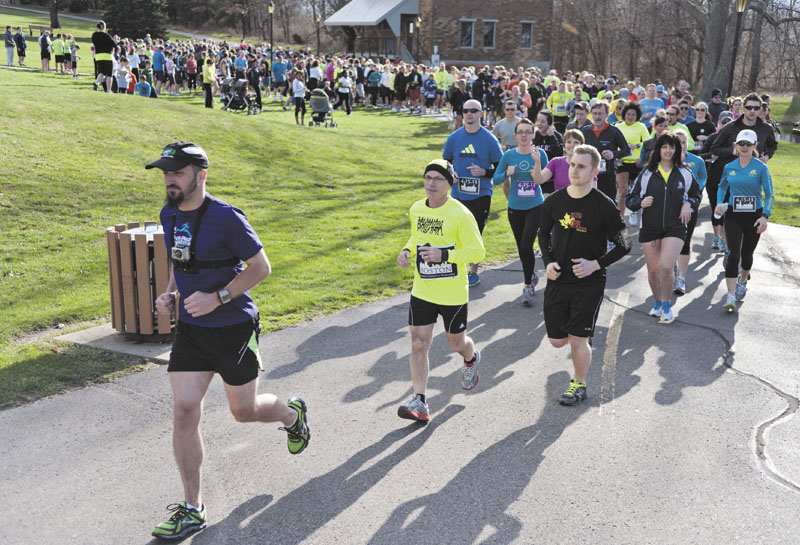 MEANINGFUL STRIDES: Brett Beier, left, leads the Solidarity run he organized Tuesday in Kalamazoo, Mich. to honor the victims of the Boston Marathon bombing. erik;holladay photography;weddi
