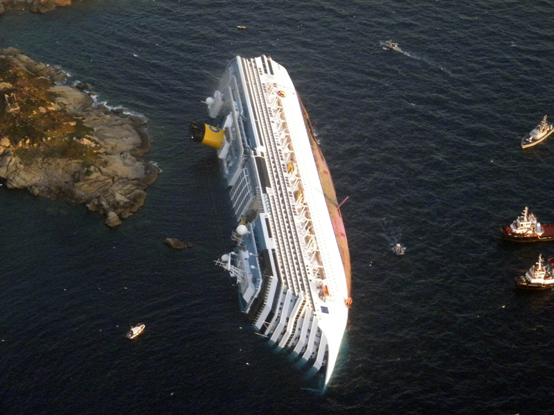 FILE - In this Jan. 14, 2012 file photo provided by the Guardia di Finanza (border Police), the luxury cruise ship Costa Concordia leans on its side after running aground off the tiny Tuscan island of Giglio, Italy. A judge in Tuscany fined Italian cruise line Costa Crociere SpA 1 million euros ($1.3 million) Wednesday, April 10, 2013 for the shipwreck that killed 32 people. (AP Photo/Guardia di Finanza, File)