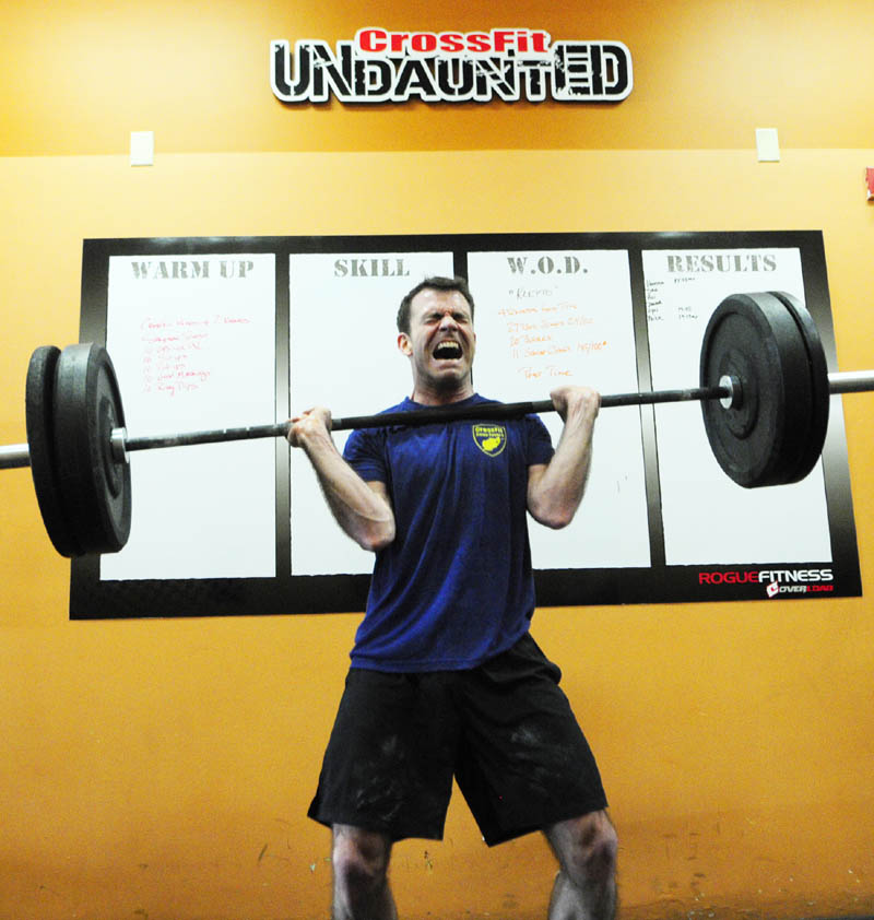 Dan Phillips does a squat clean while performing the "Klepto" Hero WOD on at CrossFit Undaunted in Augusta.