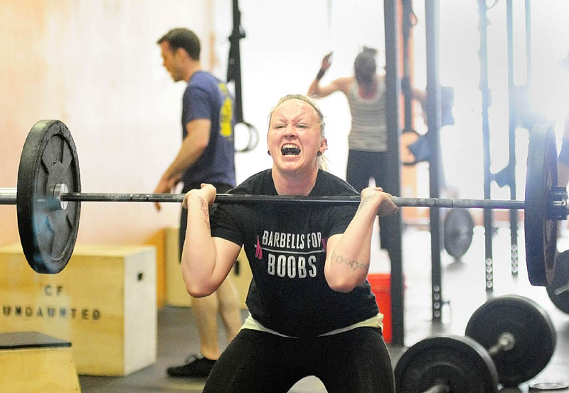 HARD WORK: Ali McLaughlin, of Winslow, does a squat clean while performing the “Klepto” Hero WOD on Saturday at CrossFit Undaunted in Augusta. The workout is named after Major David “Klepto” Brodeur, a fighter piolot killed in Afghanistan.