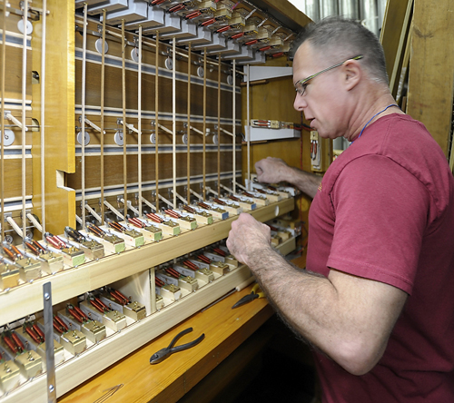 Technician David DeBlois adjusts and connects internal barrow pull-down actions on a manual chest for the solo division of the organ as he and other technicians work on refurbishing the Kotzschmar Organ from Merrill Auditorium in Portland, Maine at Foley-Baker, Inc. in Toland, Connecticut.