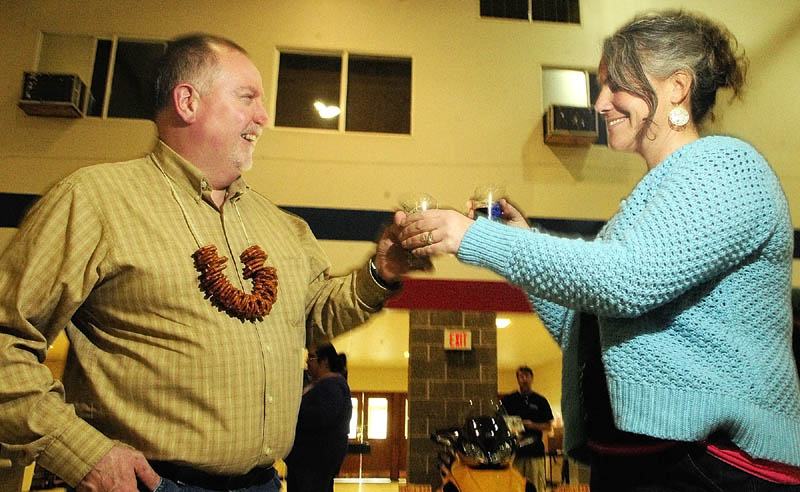 John Chapin, left, and Diana Chapin, of Montville, trade sample glasses of Allagash Black and Geary's Oakie Doakie Scotch Ale on Saturday during the Central Maine Brew Fest at the Augusta armory.