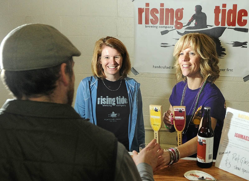 Brewery owner Heather Sanborn, left, and volunteer pourer Penny Vaillancourt talk to a customer at the Rising Tide booth on Saturday during the Central Maine Brew Fest at the Augusta armory.