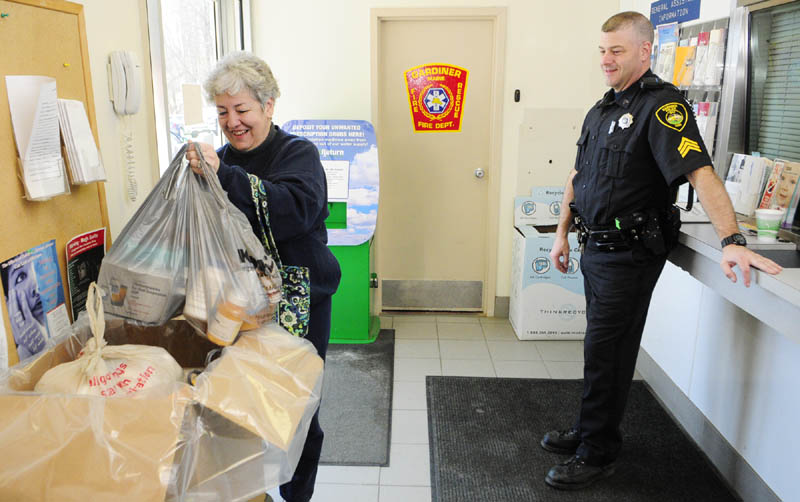 Carmen McCurdy, left, chats with Gardiner Police Sgt. Todd Pillsbury as she drops of medicine during the drug take back event in 2013 at the Gardiner police station.