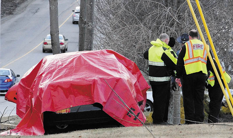 Augusta firefighters and police officers along with a Maine State Police trooper work at the scene of car accident around 6 p.m. Tuesday on Western Avenue, near the Brann Avenue intersection, in Augusta.