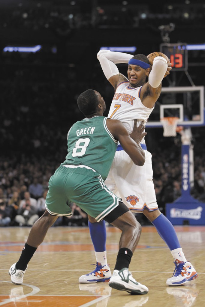 PRESSURE IS ON: Boston Celtics’ forward Jeff Green, left, defends New York Knicks’ forward Carmelo Anthony in the first half of Game 2 of their first-round NBA playoff series. The Celtics are down 0-2 as the series heads back to Boston.
