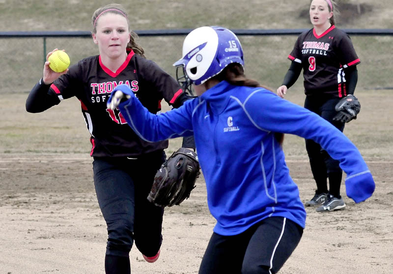 ON THE RUN: Thomas’s Alyssa Eugley runs down Colby’s Erica Pulford for the out during the Mules’ 10-0 win Wednesday in Waterville. Julie Gustafson is at right.
