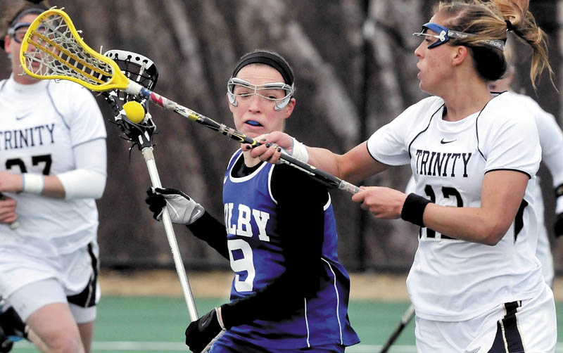MOVE OVER: Colby College’s Kirsten Karis tries to get by Trinity’s Megan Leonhard during Sunday’s game in Waterville.