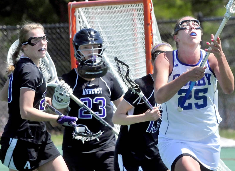 EYES ON THE PRIZE: Colby’s Lindsey McKenna looks up for ball in air near Amherst College goalie Christy Forrest (23) during the Mules 11-3 win in a New England Small College Athletic Conference quarterfinal game Saturday in Waterville.
