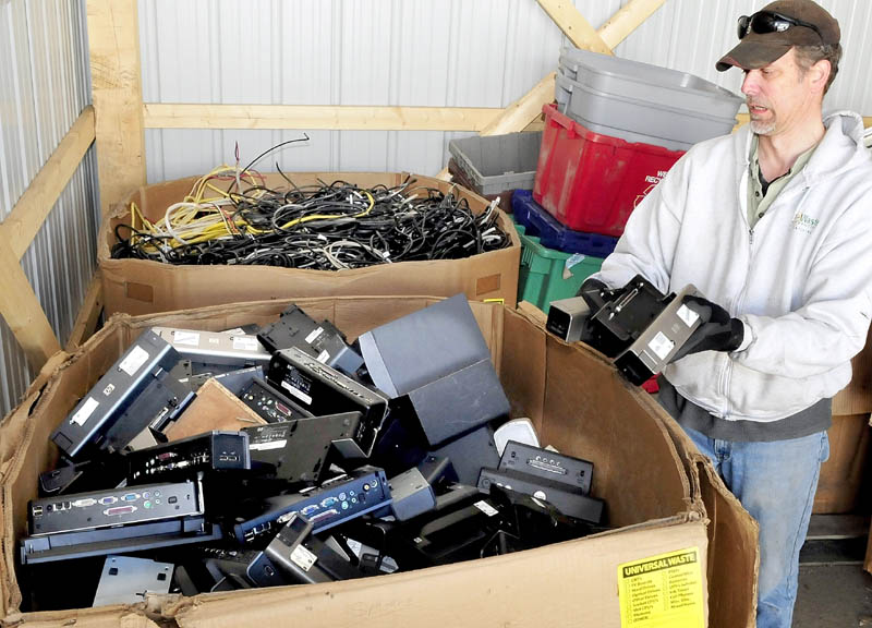 Skills Inc. Recycling Center Manager Ray Buker sorts electronic equipment to be recycled at the Waterville facility.