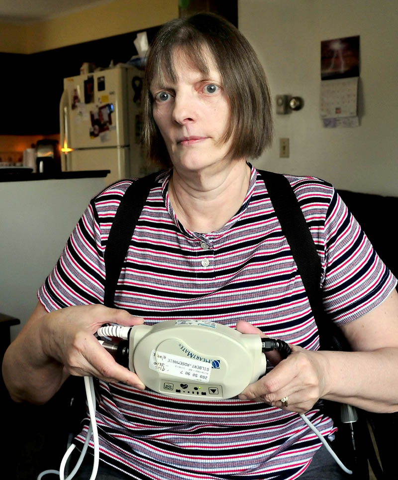 Rosemarie Gilbert, of Winslow, holds the ventricular assist mechanical pump that helps keep her heart working. Gilbert suffers from congenital heart disease and is awaiting a transplant.