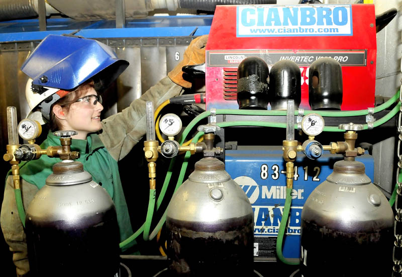 Skowhegan Area High School student Sarah Finnemore increases amperage on equipment before doing some welding in the training center at the Cianbro company in Pittsfield on Tuesday.