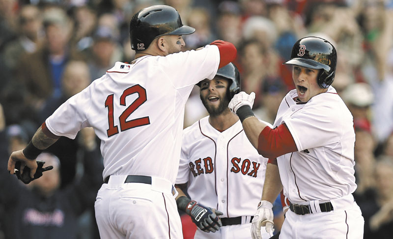 WOOOO: Boston’s Daniel Nava, right, is greeted by Dustin Pedroia, center, and Mike Napoli after hitting a three-run home run in the seventh inning of the Red Sox’ 3-1 win over the Baltimore Orioles on Monday at Fenway Park in Boston.