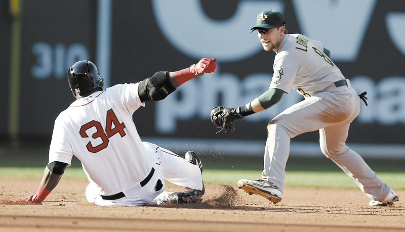 SAFE AT SECOND: Boston’s David Ortiz slides into second with a double ahead of the tag by Oakland Athletics shortstop Jed Lowrie during the Red Sox’ 6-5 win Wednesday at Fenway Park in Boston.