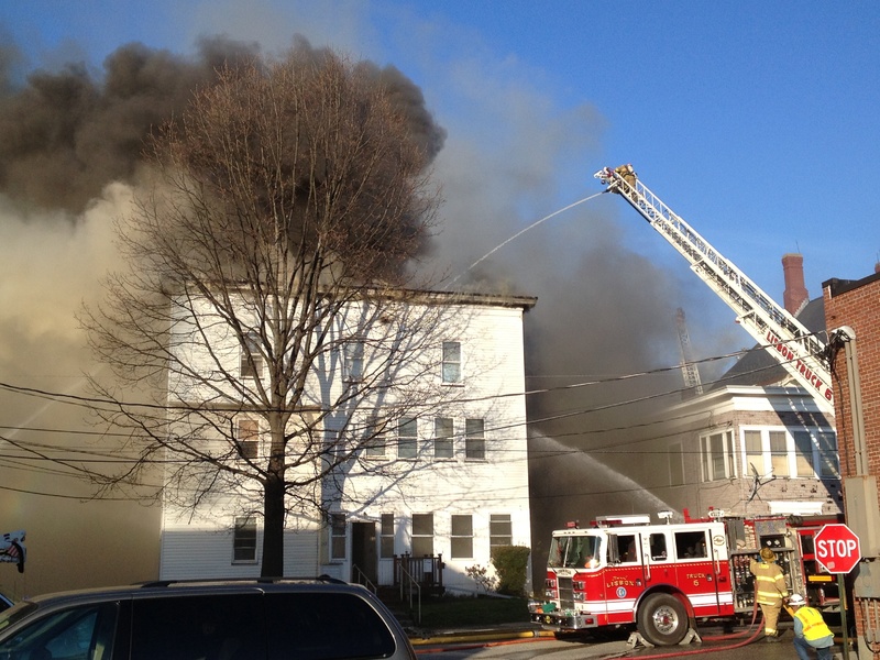 Firefighters pour water on a burning building in Lewiston on Monday. Multiple buildings were on fire.