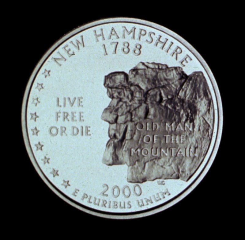 The New Hampshire quarter shows a representation of the Old Man of the Mountain.