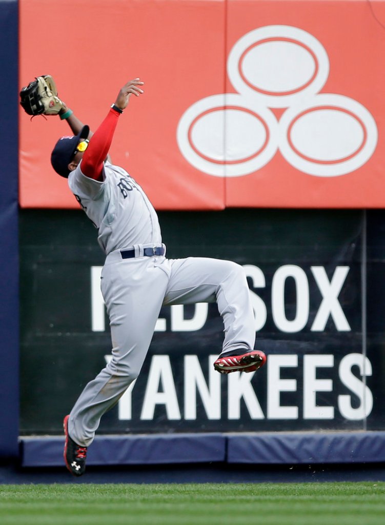 Jackie Bradley Jr. makes an acrobatic catch on Robinson Cano’s deep drive to left field in the third inning at Yankee Stadium.