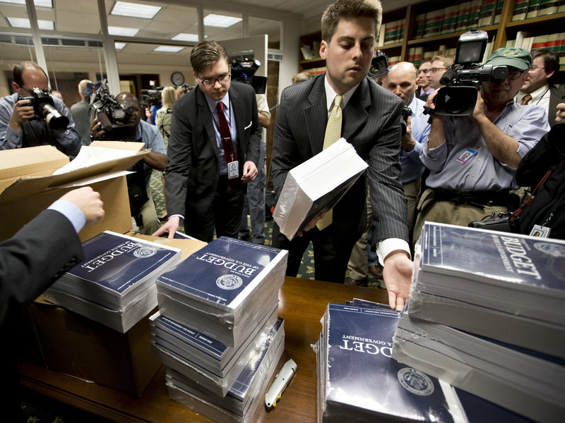 Copies of President Obama's budget plan for fiscal year 2014 are distributed to Senate staff on Capitol Hill on Wednesday.