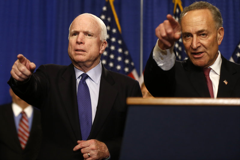 Sen. John McCain, R-Ariz., left, and Sen. Charles Schumer, D-N.Y., take questions on immigration reform legislation Thursday on Capitol Hill.