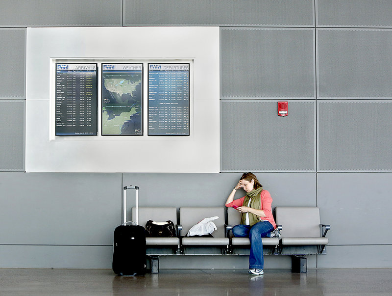 Lauren Messner of New York City waits for her delayed flight home at the Portland International Jetport in Portland Monday afternoon on April 22, 2013. Messner, originally from Portland, was told when she checked-in that her flight was delayed for one hour due to the air-traffic controller cutbacks.