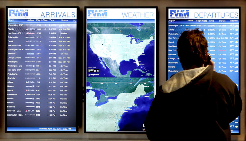 Nick Repenning of Whitefield checks the flight screen to see if a flight is on time at the Portland International Jetport in Portland Monday afternoon on April 22, 2013.