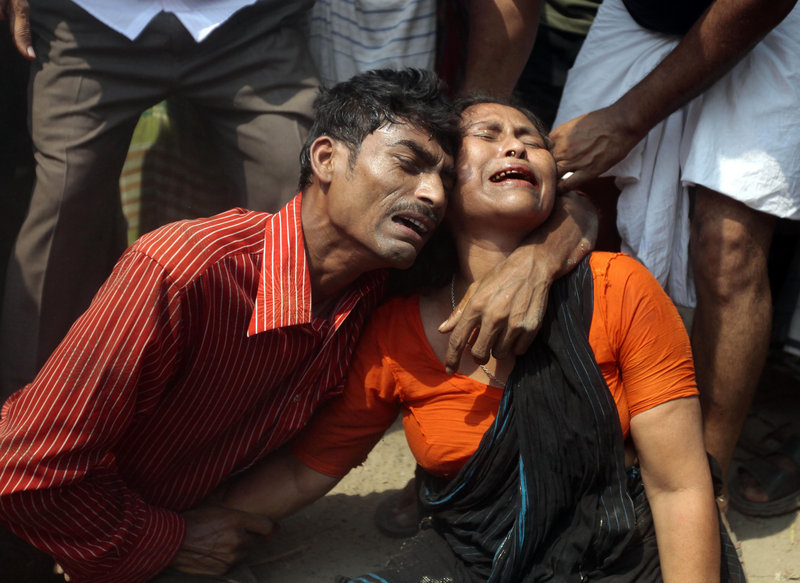 Relatives mourn a victim at the site where an eight-story garment factory collapsed in Savar, Bangladesh, on Wednesday, killing at least 87 and leaving many more trapped in the rubble.