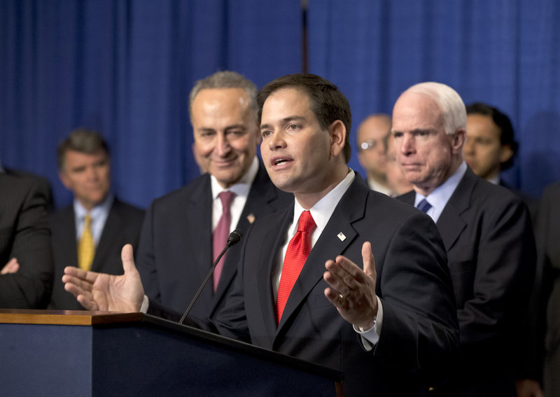 Sen. Marco Rubio, R-Fla., is flanked by Sen. Charles Schumer, D-N.Y., left, and Sen. John McCain, R-Ariz., as Rubio speaks about immigration reform legislation April 18.