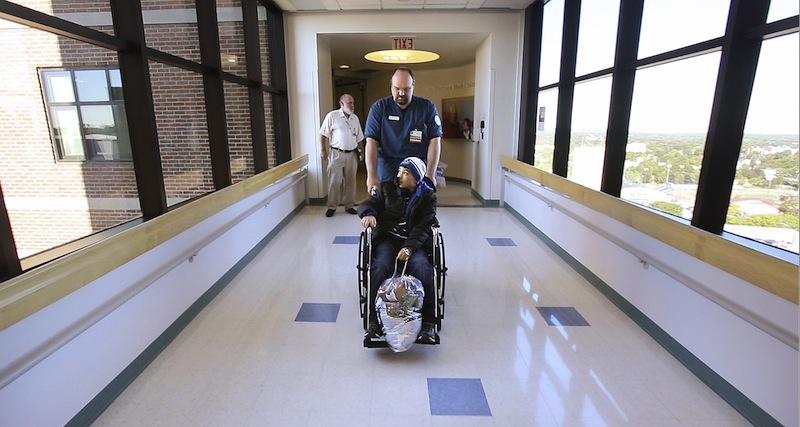 In this September 2012 file photo, a patient is wheeled out of Barbara Bush Children's Hospital at Maine Medical Center in Portland. Maine Democrats in the Legislature continued their push Wednesday for an expansion of publicly funded health insurance for low-income Mainers and moved to link the expansion with Gov. Paul LePage's plan to pay hospitals about $484 million in outstanding Medicaid reimbursements.