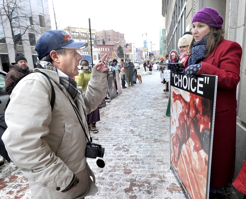 Pro-choice and anti-abortion protesters exchange words in front of the Planned Parenthood clinic at 443 Congress St. in Portland in January. A public hearing was held Thursday in Augusta on three abortion-related bills.