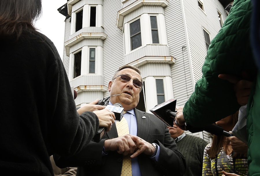 Gov. Paul LePage addresses the media Tuesday at the scene of the Bartlett Street fire in Lewiston.