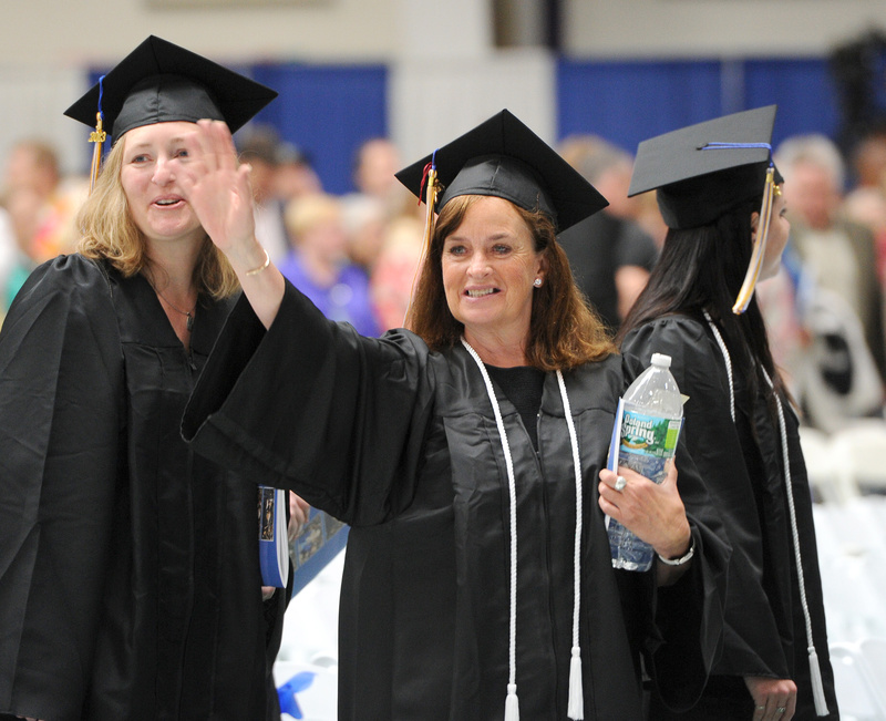 Elizabeth Murphy, of Kennebunkport, waves to family during Saturday's 133rd commencement at the University of Southern Maine in Gorham.