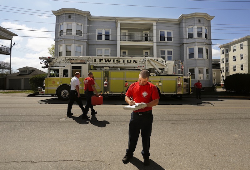 Lt. James Pelletier of the Lewiston Fire Dept. completes a vacant building inspection on Walnut Street Friday, May 10, 2013.