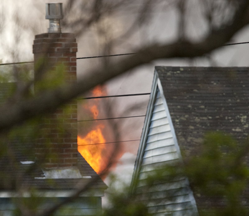Flames at 16 Hillview Ave. in Saco are visible between neighboring houses.